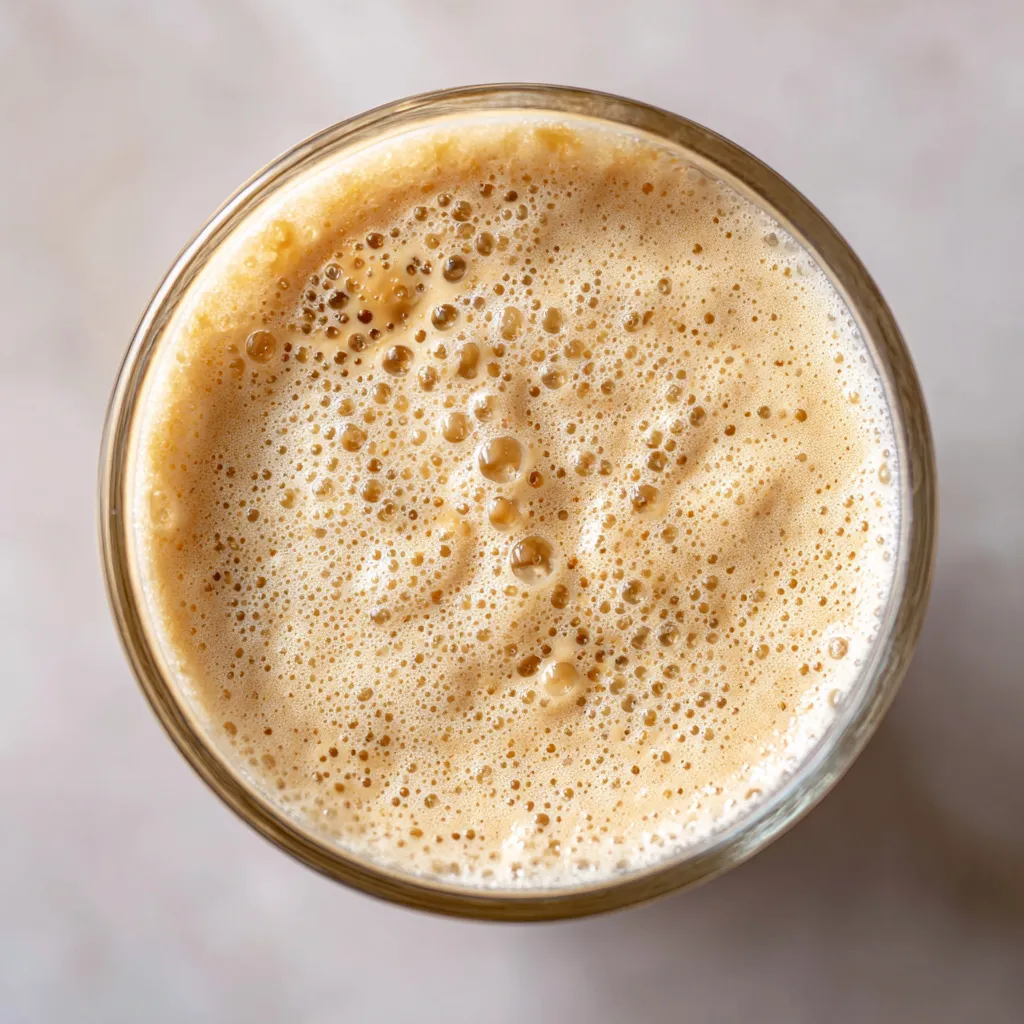 A glass of beer with bubbles.