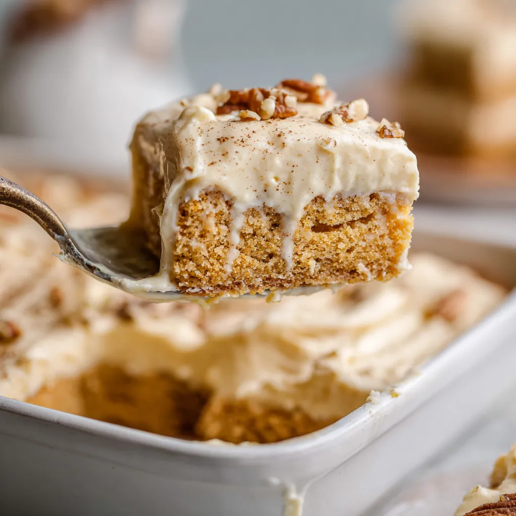 A spoon is being used to eat a piece of cake.