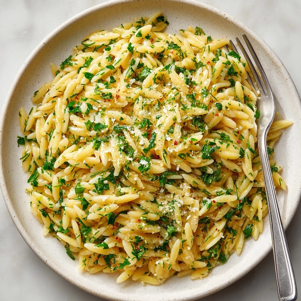 Serving suggestion: A bowl of steamy, fragrant Herb Butter Orzo beside grilled salmon.