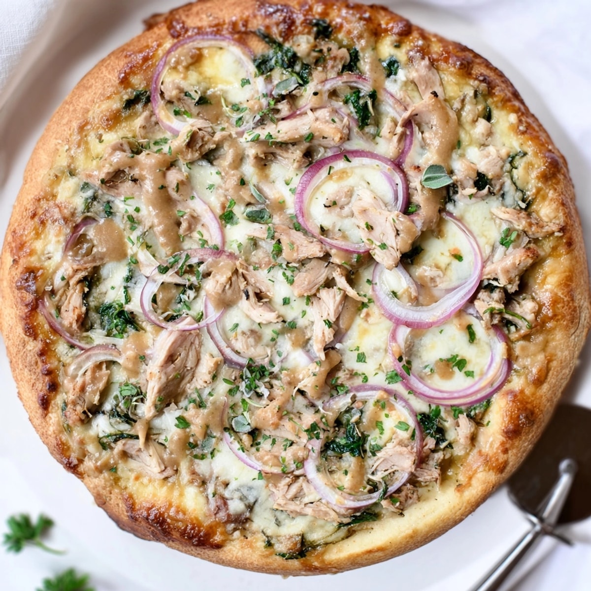 Savory slices of Sage Turkey Gravy Pizza, a flavorful way to enjoy holiday dinner leftovers.