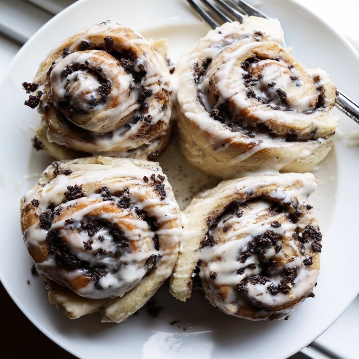 Golden brown Protein Cookie Dough Sweet Rolls with a drizzle of vanilla glaze sit warm.