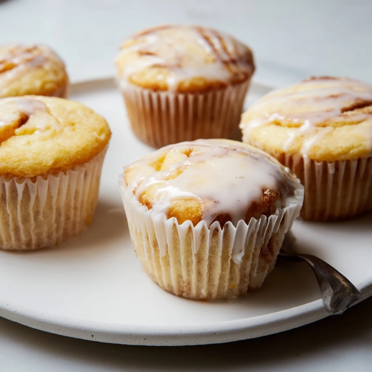 Elegant vanilla cupcakes featuring a creamy ricotta filling and aromatic cinnamon swirl.