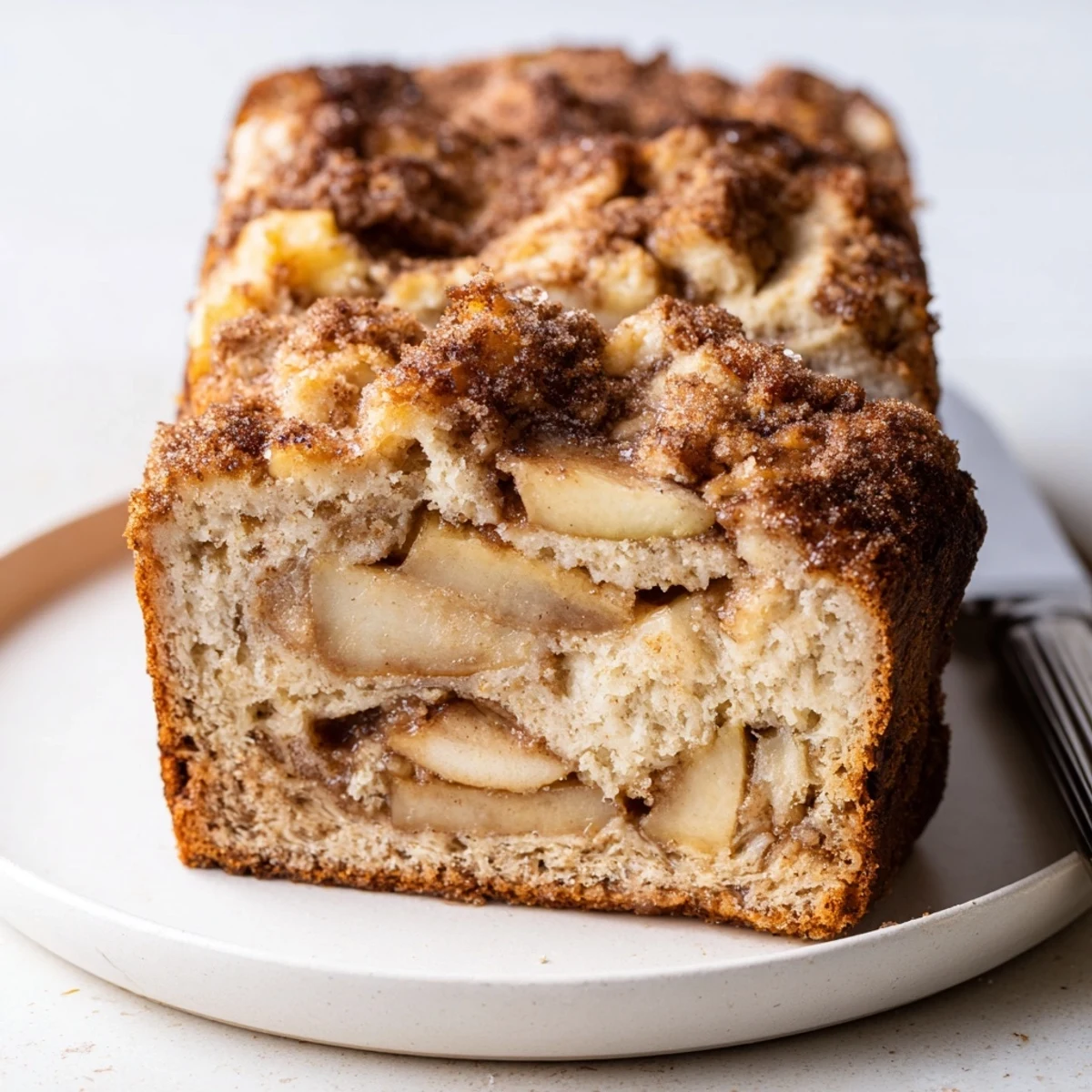 Slices of Ricotta Apple Cinnamon Bread highlighted by sweet cinnamon and juicy apple bites.