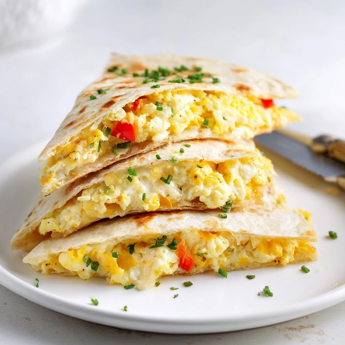 Savory ricotta cheddar breakfast quesadilla, ready to serve with salsa or avocado slices.