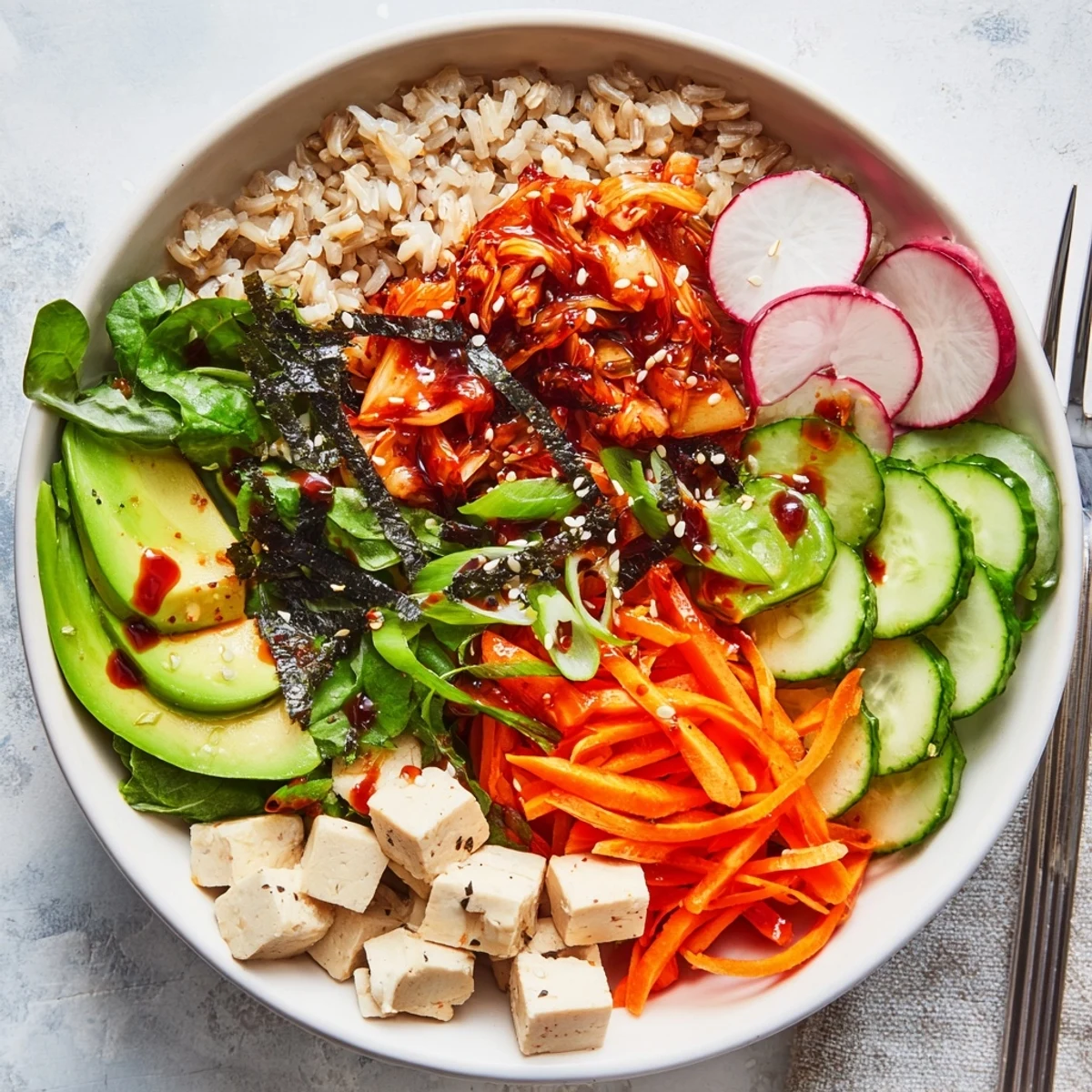 Vibrant fermented vegetable bowl topped with tangy kimchi and fresh garnishes.  