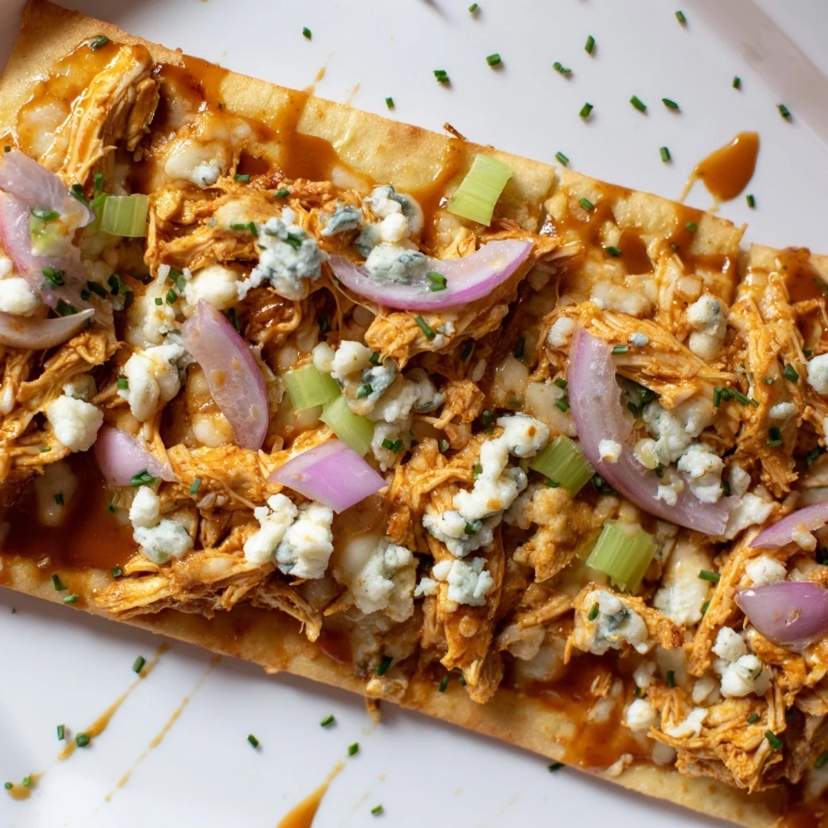 Golden-brown buffalo chicken & blue cheese flatbread, drizzled with creamy dressing for extra flavor.  