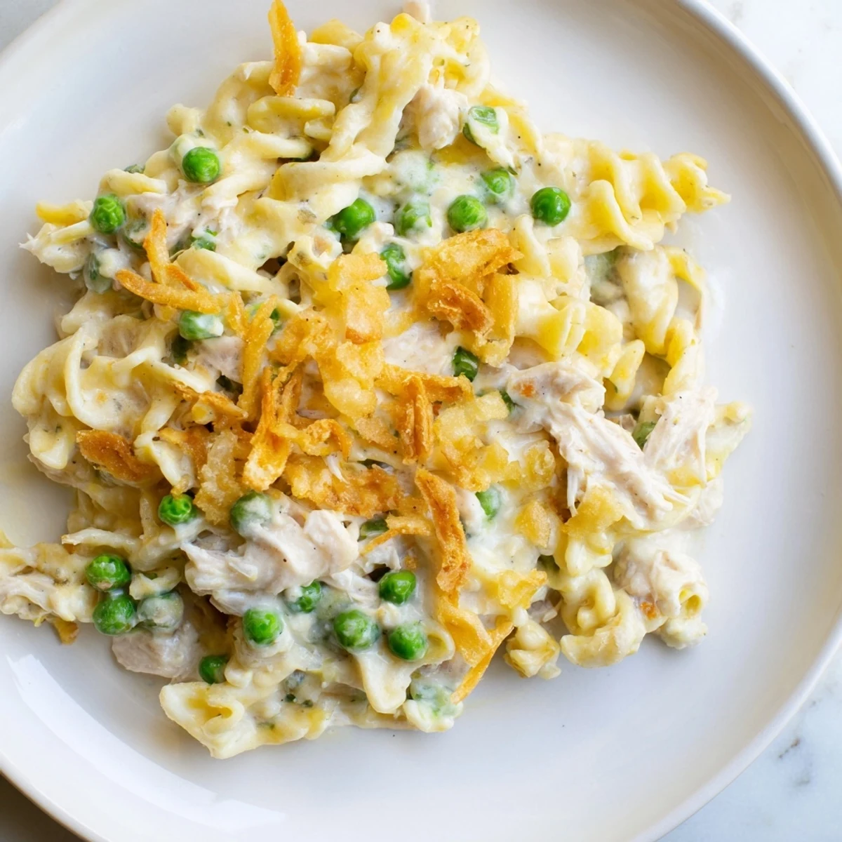 Golden baked Homemade Tuna Noodle Casserole, topped with crispy onions, ready to serve with family.
