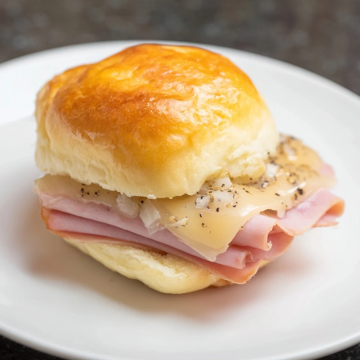 Cheesy and delicious, these Baked Ham and Cheese Party Sliders are stacked high, ready for serving warm.