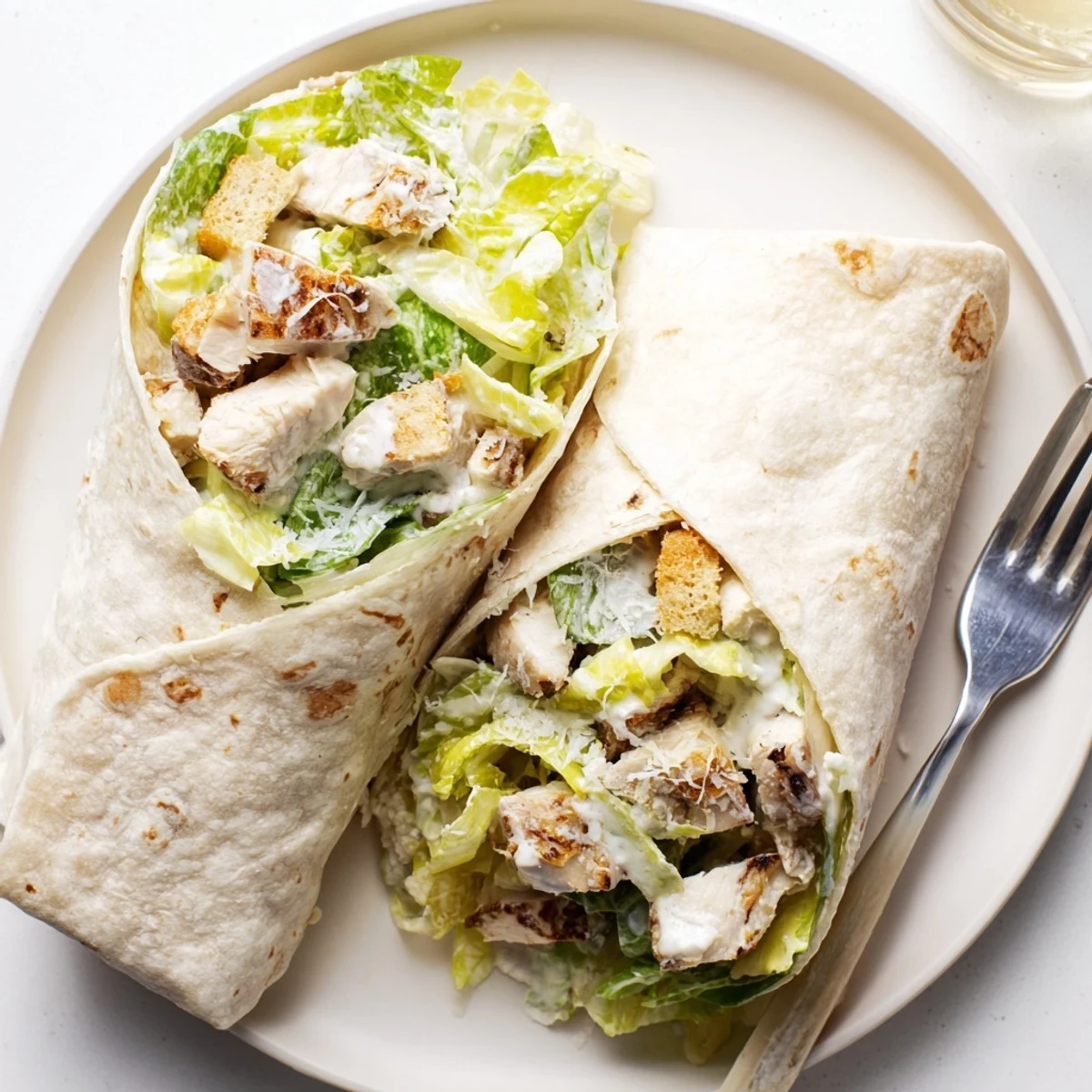 A close-up of delicious chicken Caesar wraps, showcasing the savory chicken and crunchy croutons inside.
