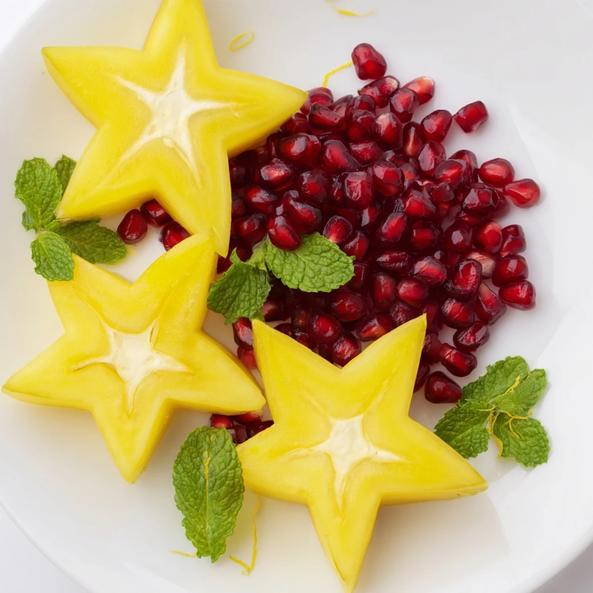 A colorful close-up of the pomegranate and mint star fruit platter, ready to serve and enjoy.