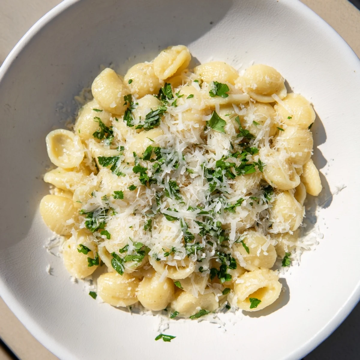 Steaming bowl of 15-Minute Garlic Parmesan Pasta, glistening with creamy, cheesy sauce and herbs.