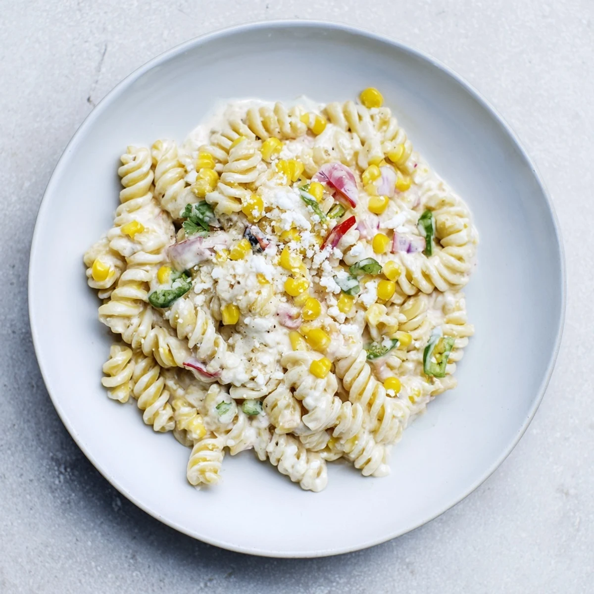Bright and colorful One-Pot Mexican Street Corn Pasta, ready to eat with a squeeze of lime.
