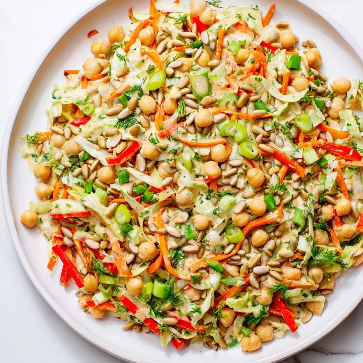 Freshly made Fiber-Forward Chickpea Salad, showcasing crisp greens and crunchy carrots, perfect for lunch.