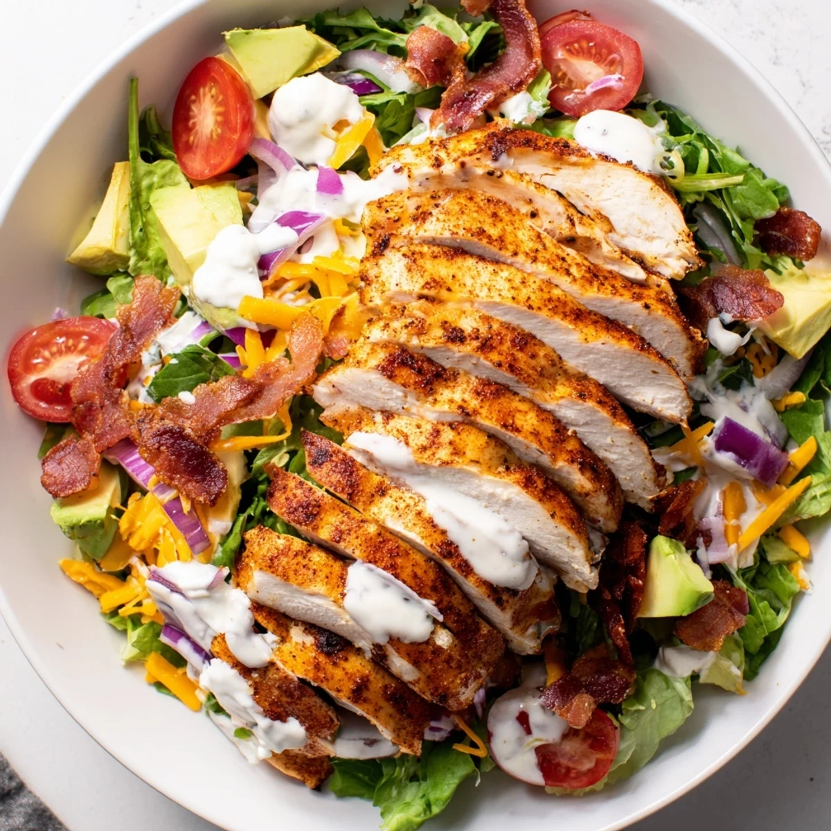 Crispy Bacon Chicken Salad with juicy grilled chicken, crunchy bacon, and creamy ranch dressing on fresh greens.