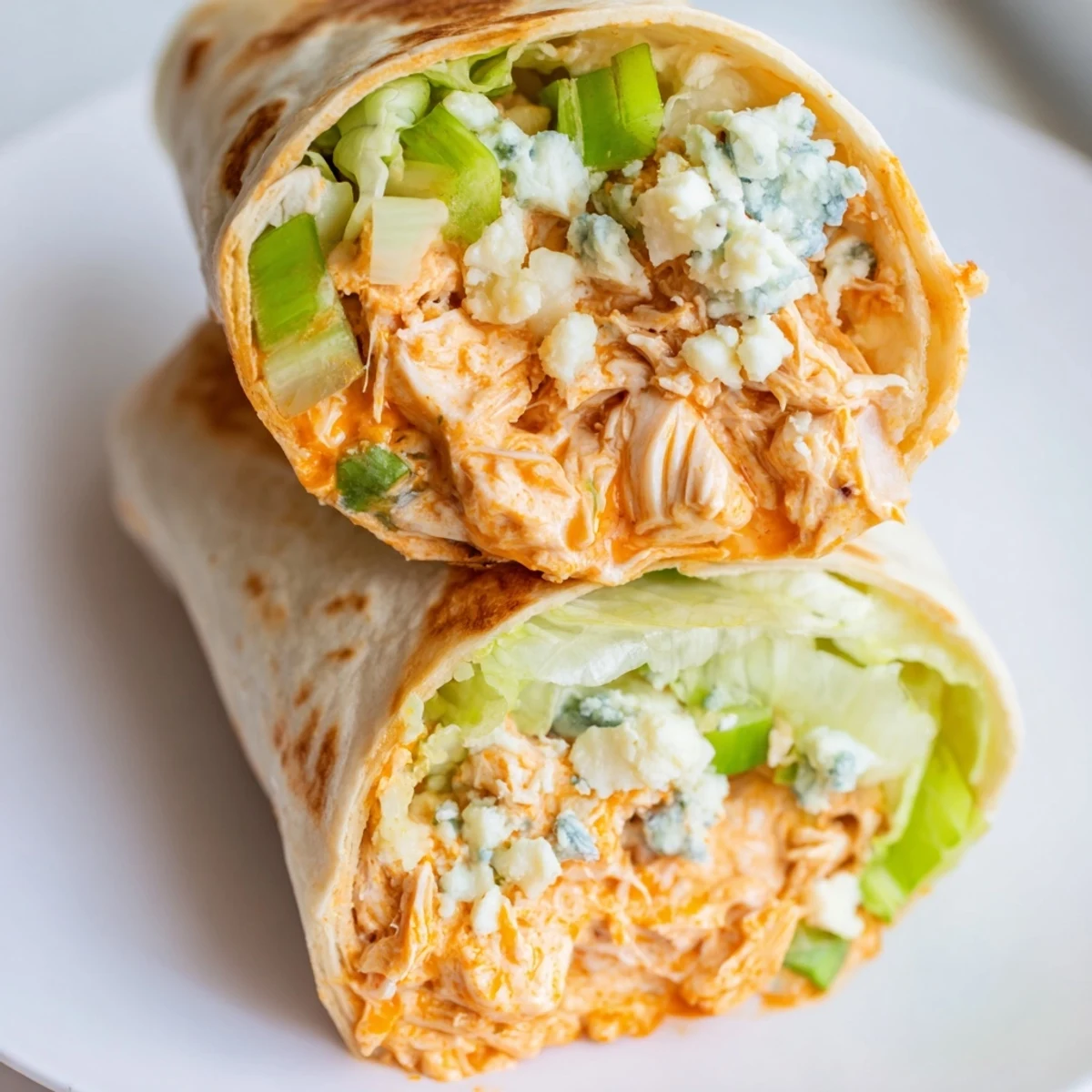 Mouthwatering, golden-brown Buffalo Chicken Dip Wrap, sliced to reveal a flavorful chicken and cheese interior.