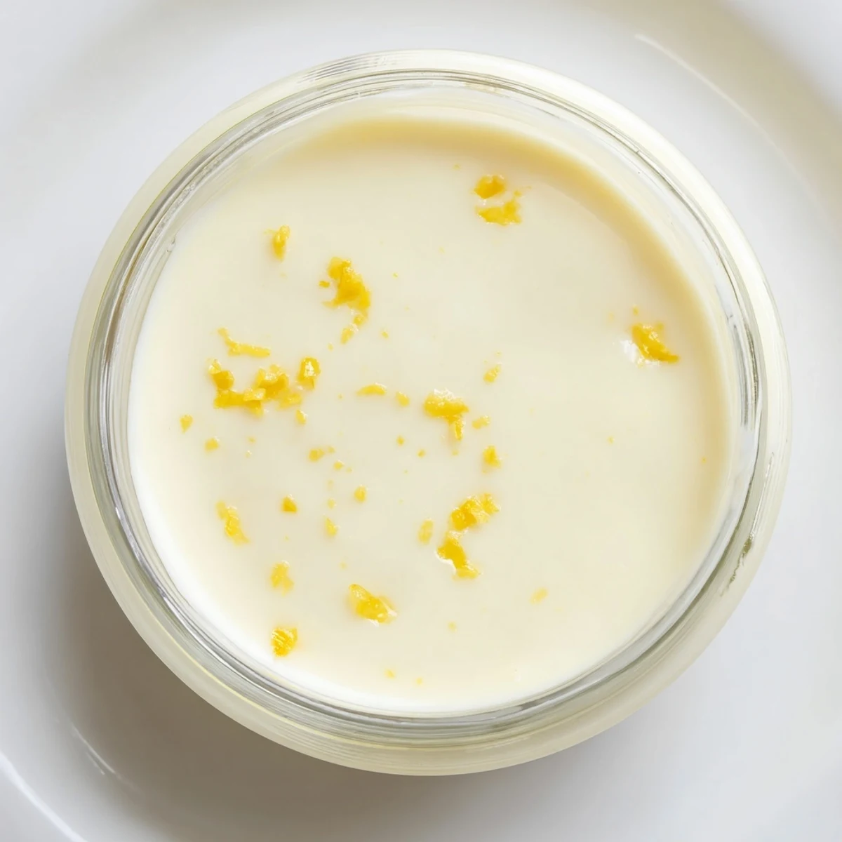Tangy 3-Ingredient Lemon Posset served in glass ramekins, perfectly chilled and ready to enjoy with a hint of lemon zest.