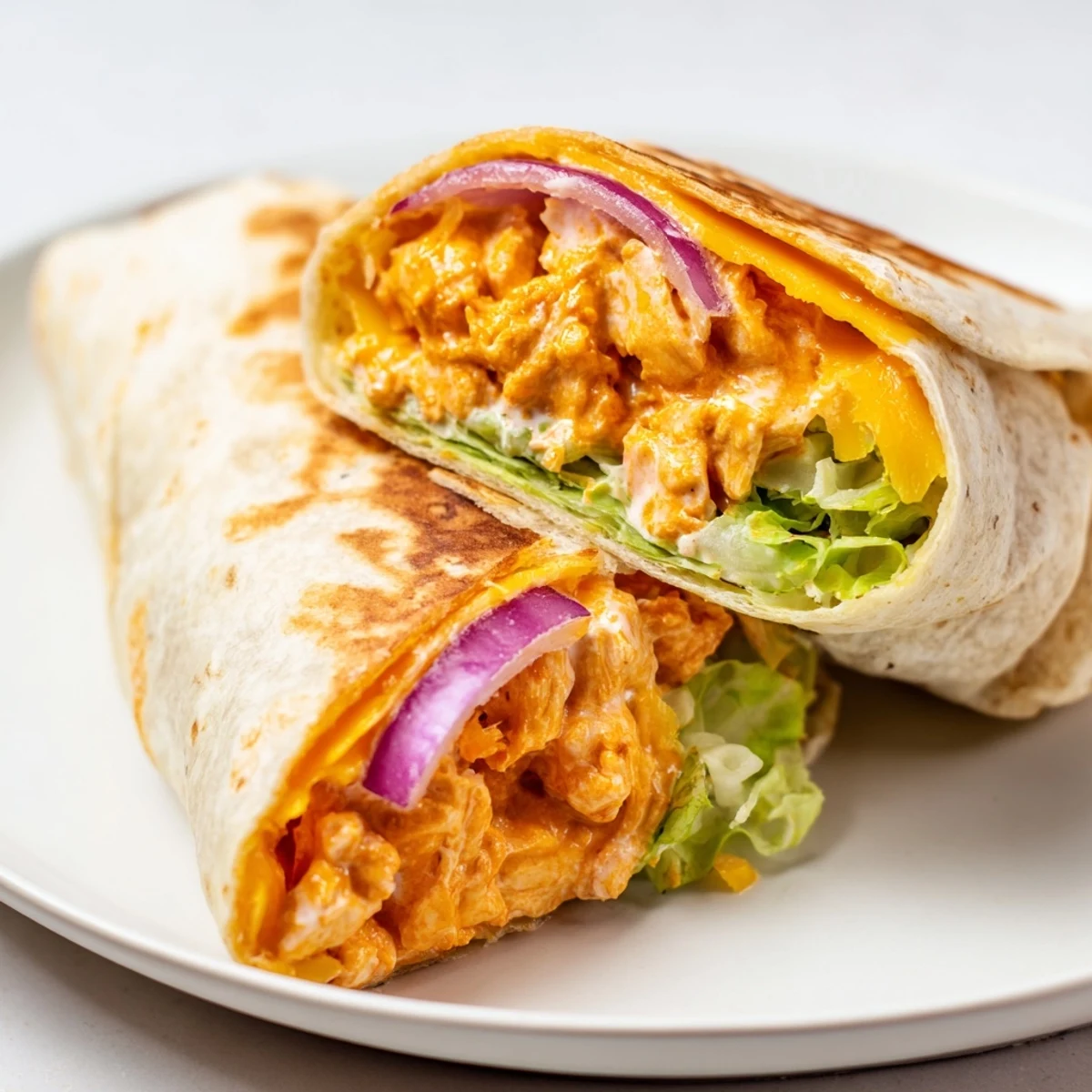 Juicy Buffalo Ranch Chicken Wrap, filled with savory chicken, cheese, and fresh lettuce, ready to eat.