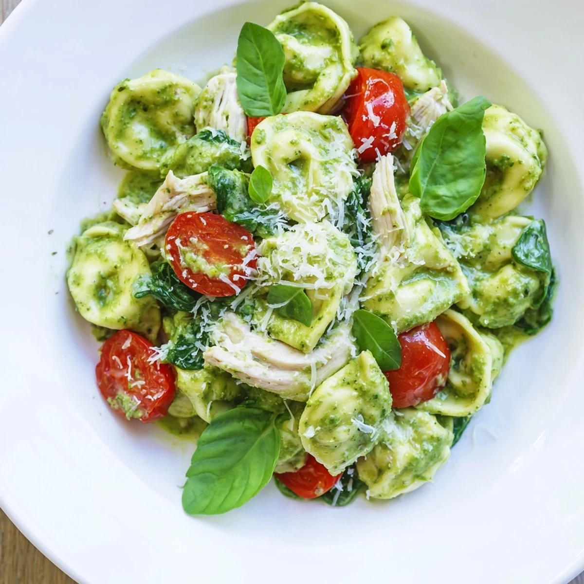 Delectable Creamy Pesto Tortellini Skillet with fresh spinach and vibrant cherry tomatoes, ready to serve.
