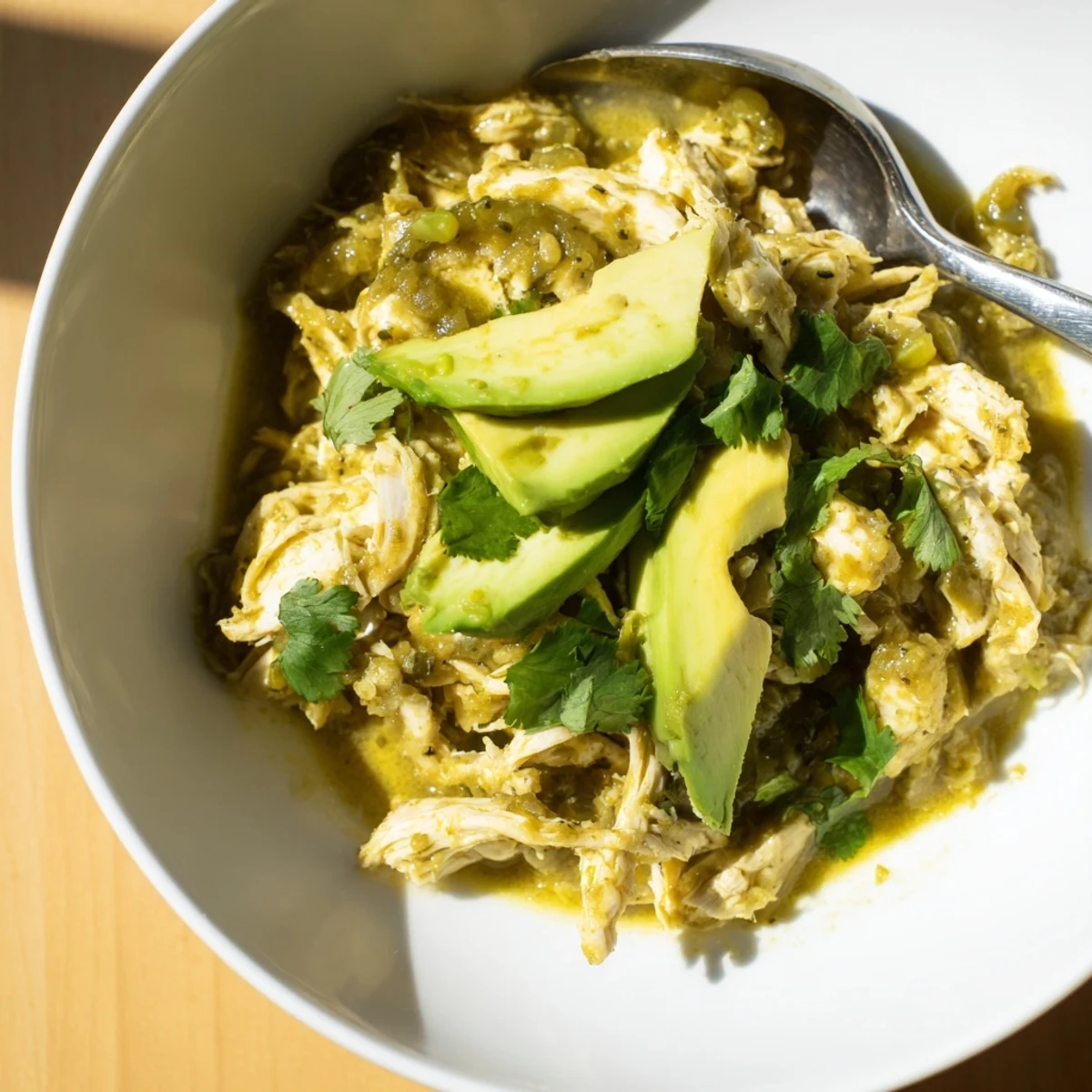 Tender shredded chicken simmered in a vibrant tangy tomatillo and roasted pepper sauce for a comforting Chicken Chili Verde.