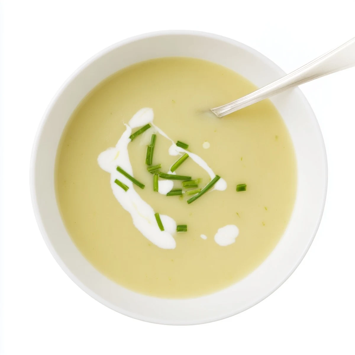 Smooth and creamy potato leek soup in a white bowl, garnished with fresh parsley and a light drizzle of olive oil.