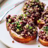 Golden, toasted crostini topped with creamy, vibrant Cranberry Jalapeño Tapenade, ready to serve.
