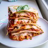 Crispy tortillas filled with Cheesy Eggplant Parmesan Quesadillas, bursting with melty cheese goodness.