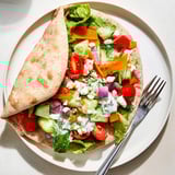 A vibrant photo of open Garlic Ranch Veggie Pita Pockets with creamy dressing.