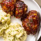 Oven-baked honey BBQ chicken thighs paired with buttery garlic mashed potatoes for comfort.  