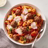 A comforting Italian Meatball Pasta Skillet loaded with meatballs, pasta, and fresh basil.  