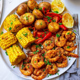 Colorful Cajun shrimp and sweet corn dish, perfect for summer gatherings and barbecues.  
