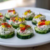 Beautiful Holiday Star Cucumber Bites with colorful pepper and fresh dill make a perfect appetizer.
