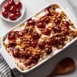 A white bowl with a dessert in it.