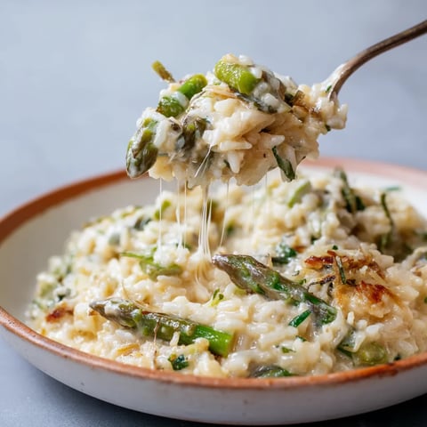 A bowl of rice with green vegetables.