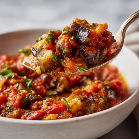 A spoon is in a bowl of food.