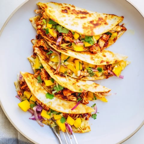 Golden mango chipotle chicken quesadillas: Warm tortillas filled with savory chicken and fresh mango.