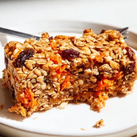 Golden-baked Protein Carrot Cake Oat Bars, studded with nuts, ready for a healthy snack.