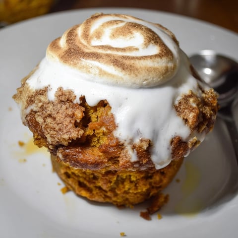 Golden brown pumpkin muffins with marshmallow swirl; freshly baked, ready to enjoy.