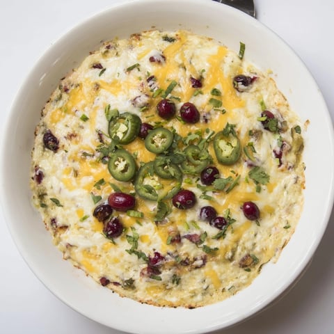Golden-baked Cranberry Jalapeño Queso Dip, a warm, cheesy, festive delight ready to scoop.