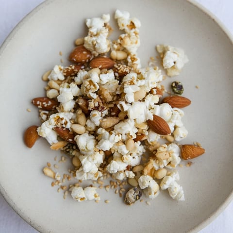 Close-up of crunchy Holiday Snack Mix: Sesame Popcorn & Miso Almonds, ready for gifting.