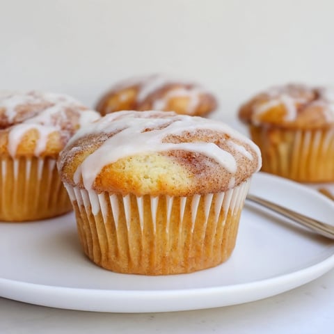 Tender cinnamon swirl ricotta cupcakes topped with a sweet glaze for dessert lovers.  