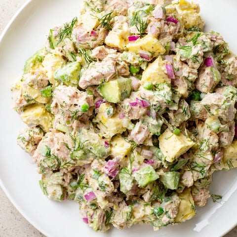 Creamy avocado ranch tuna egg salad served on whole grain toast slices.  