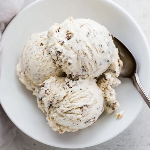 Creamy cottage cheese ice cream topped with edible cookie dough balls for indulgent delight.  
