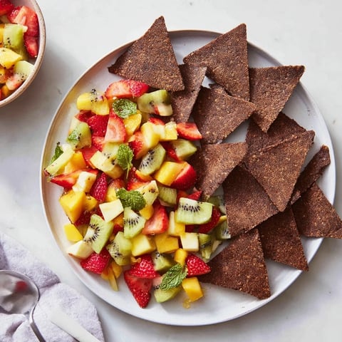 Crispy chocolate tortilla chips paired with colorful, fresh fruit salsa for dessert.  