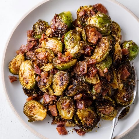 Crispy Maple Bacon Brussels Sprouts drizzled with sweet syrup, perfect for any meal.  