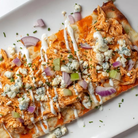 Spicy buffalo chicken & blue cheese flatbread topped with fresh chives and crispy veggies.  