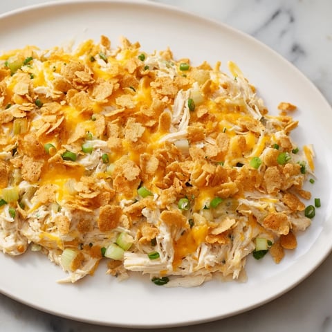 Golden, bubbly Neiman Marcus-Style Chicken Casserole boasts a crispy topping and creamy, cheesy filling, ready to serve.