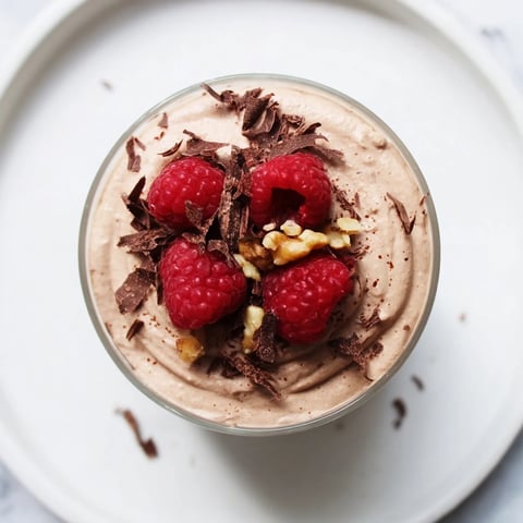 Thick and creamy no-bake cottage cheese chocolate mousse, topped with fresh berries, ready to serve.