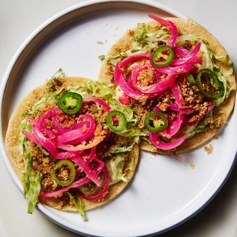 Bright, colorful 5-Minute Pickled Red Onion Tacos with a creamy avocado crema, ready to enjoy.