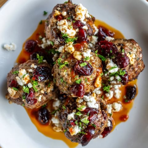 Tender Cranberry Feta Meatballs smothered in glistening sweet chili sauce, ready to serve as an appetizer.