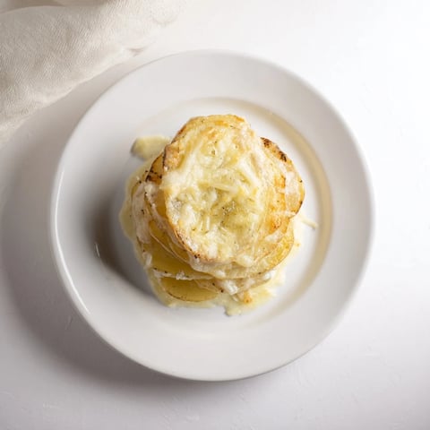 Golden brown Kombu-Infused Creamy Potato Gratin, bubbly and fragrant, ready for serving alongside dinner.